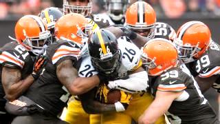 Steelers running back Le'Veon Bell burrows through a host of Browns defenders